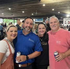 The SURE Title team with friends at a community event