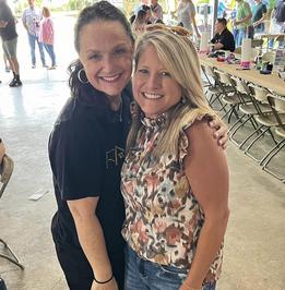 Two guests smiling at a community event